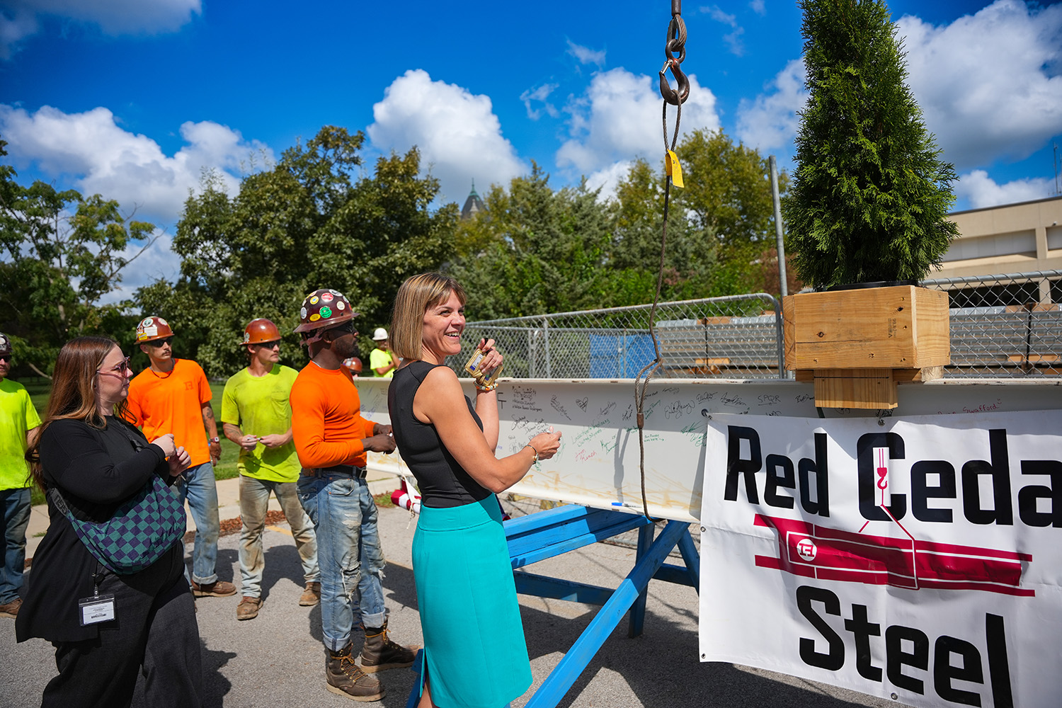 Employees and staff signing steel beam