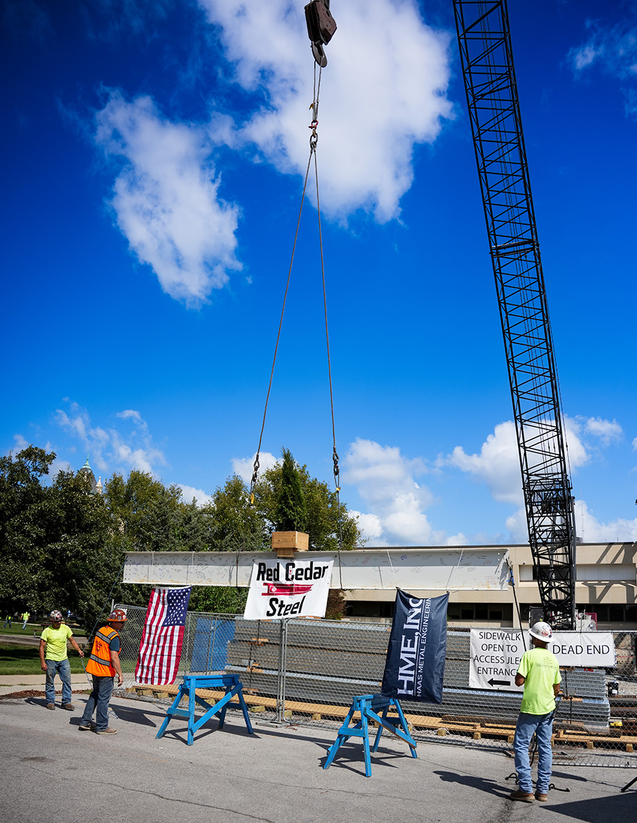 Crane lifts steel beam