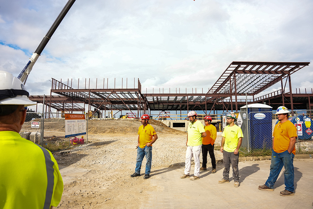 Workers in front of building scaffolding