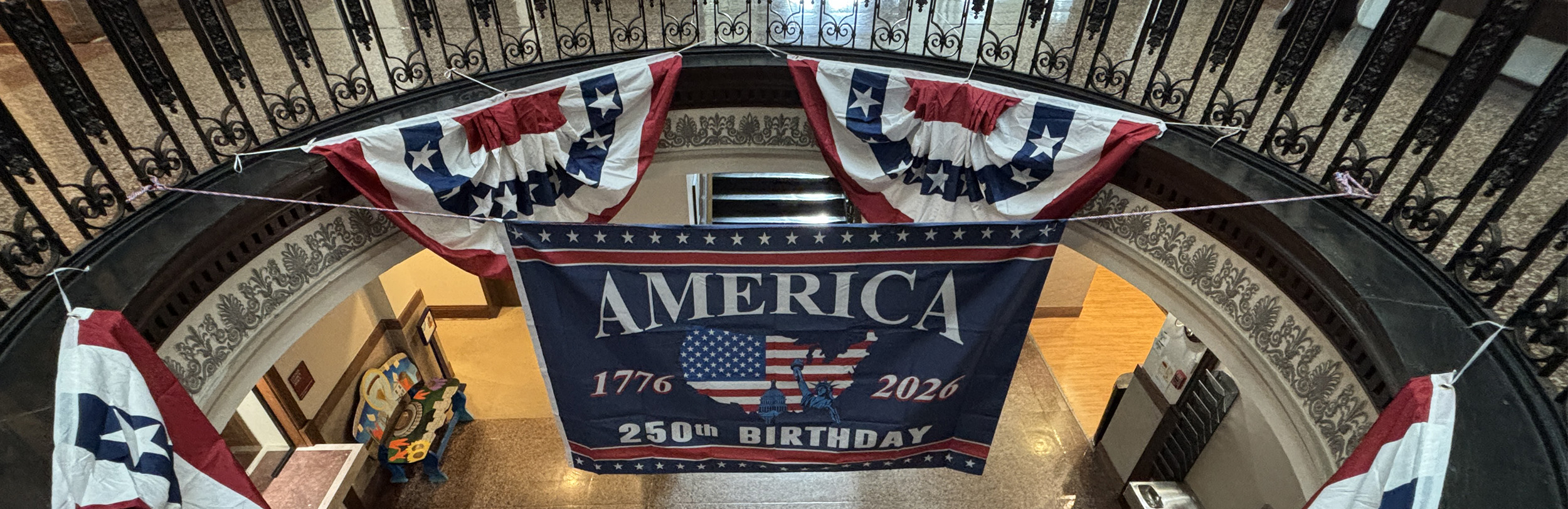 American at 250 flag is displayed in courthouse