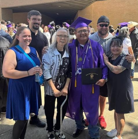 Tim Shoulderblade is pictured with Artists Helping the Homeless founder Kar Woo after receiving an associates degree from Haskell Indian Nations University.
