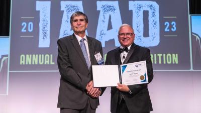 Douglas County Appraisal Analyst August Dettbarn, left, receives a fellows award from the International Association of Assessing Officers (IAAO).