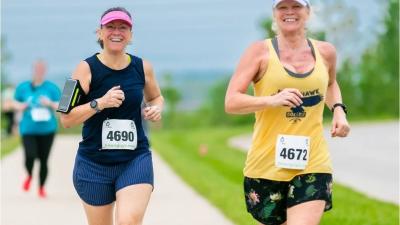 Race participants smiling whiling running towards the camera during the event