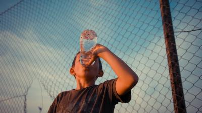 Youth drinking water on a warm summer evening