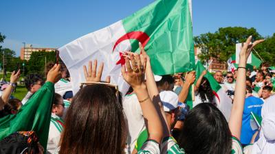 Participants cheer at Algerian Flag event